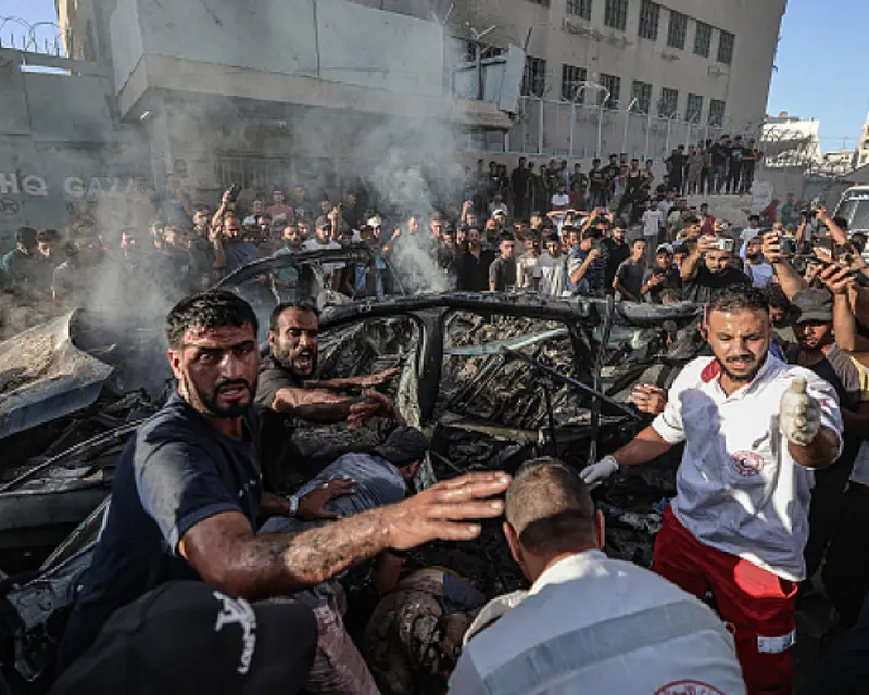 Displaced Palestinians beside tents in Gaza amid a worsening humanitarian crisis